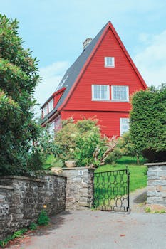 Charming red house with garden, traditional architecture, outdoors in Bergen, Norway.