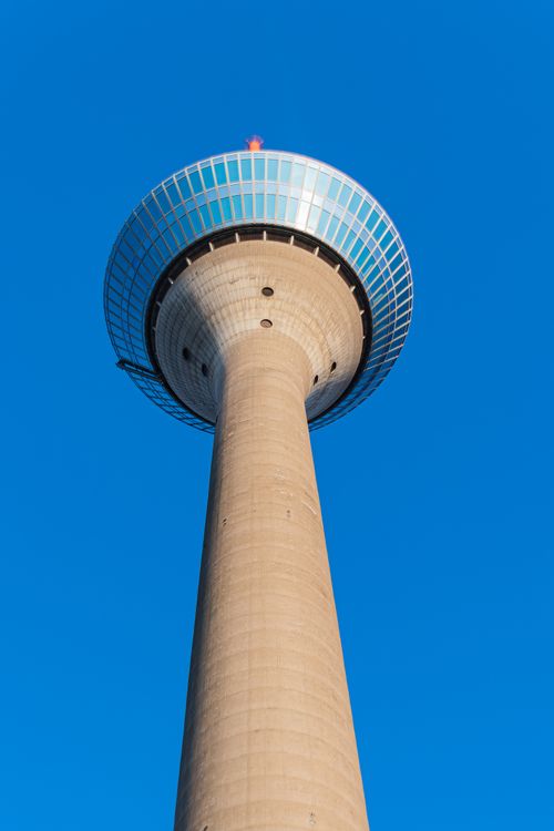 Free Low angle view of the Rheinturm in Düsseldorf with clear blue sky, showcasing modern architecture. Stock Photo