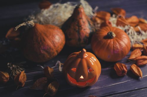 Free A cozy Halloween scene with carved pumpkins and autumn leaves, perfect for seasonal decoration. Stock Photo