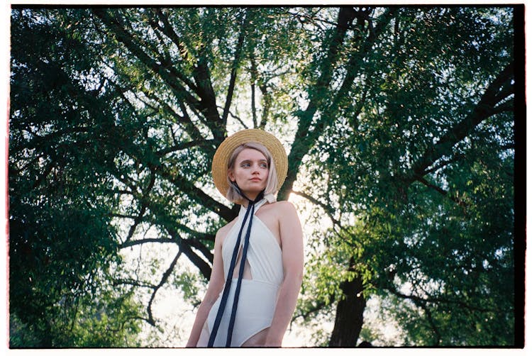 Woman In Hat Under Tree Crown