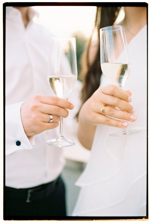 Photograph of Wine Glasses in Mans and Womans Hands