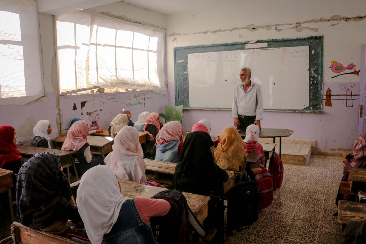 Teacher leading a classroom lesson with students in Idlib, Syria