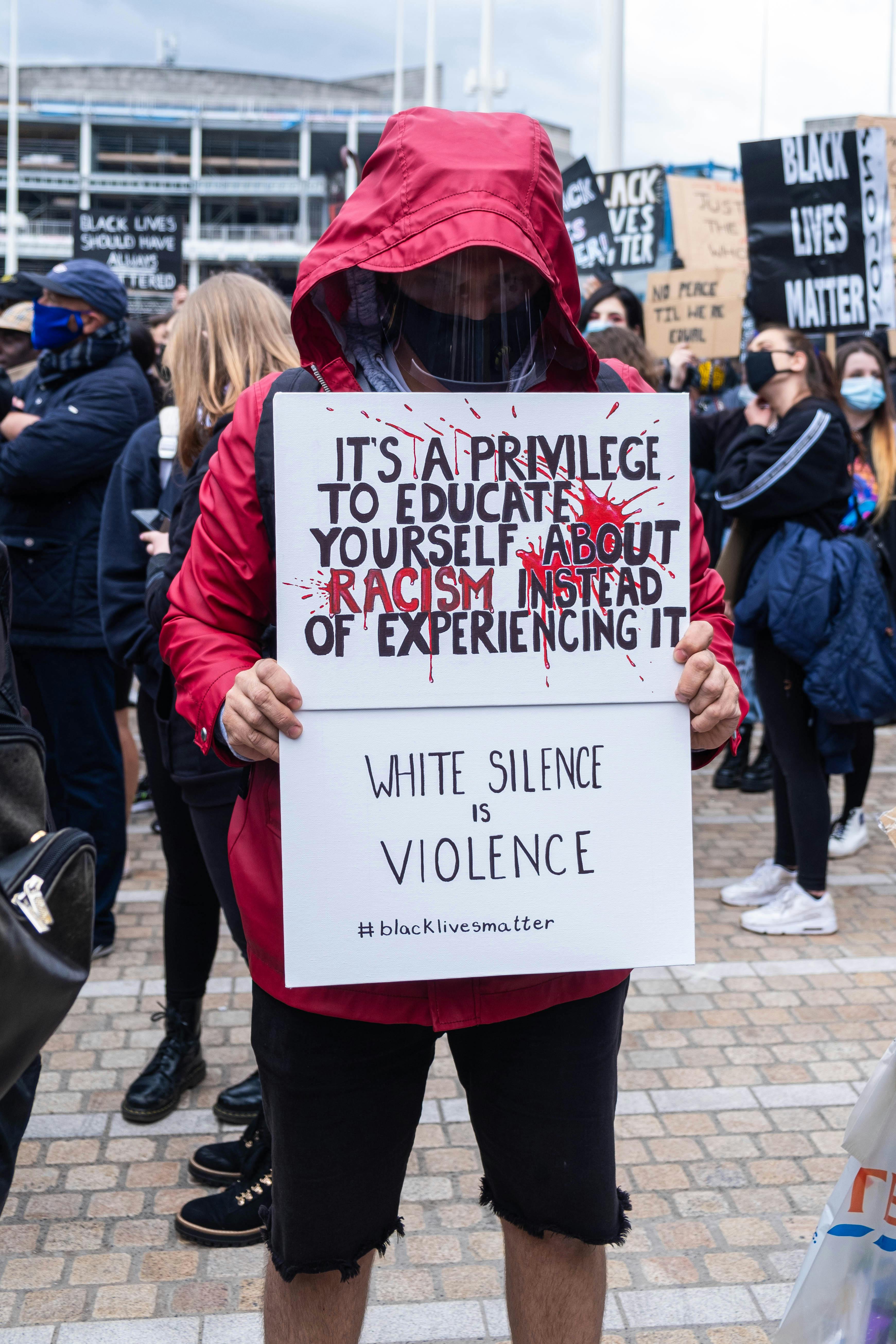 activist holding a white placard