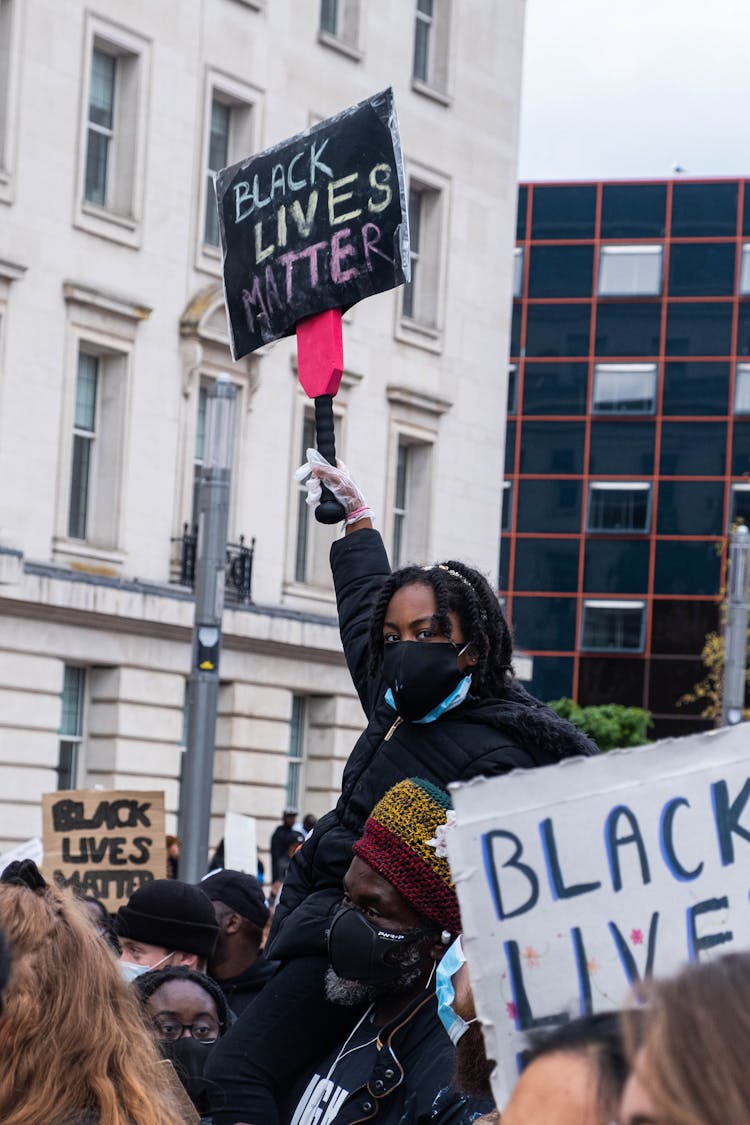 A Group Of People Protesting On The Street