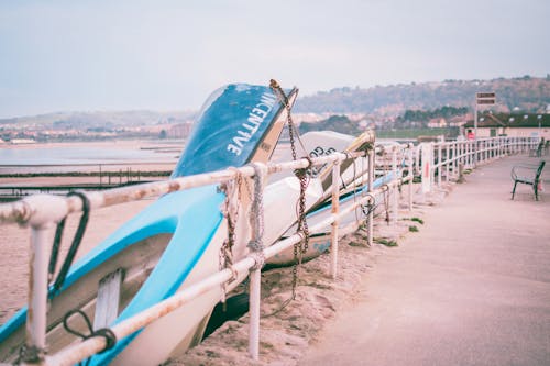 Free Photo of White and Blue Boats Beside White Railings Stock Photo