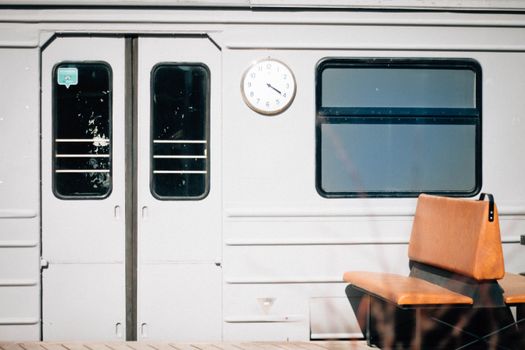 Interior view of a train featuring a clock and seating area, evoking travel and transportation themes.