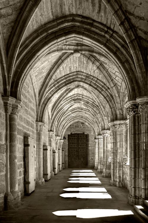 Free Sunlight casts shadows through Gothic arches in a historic Trujillo cathedral, Spain. Stock Photo