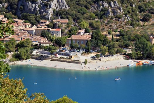 Aerial shot of a scenic beach and town in Nice, capturing vibrant waterfront activities.