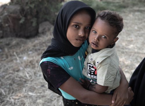 Free A tender moment between siblings outdoors, capturing love and care. Stock Photo
