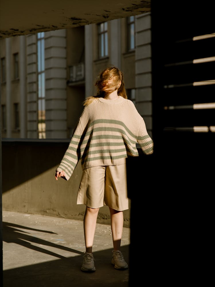 A Woman Wearing A Brown Sweater