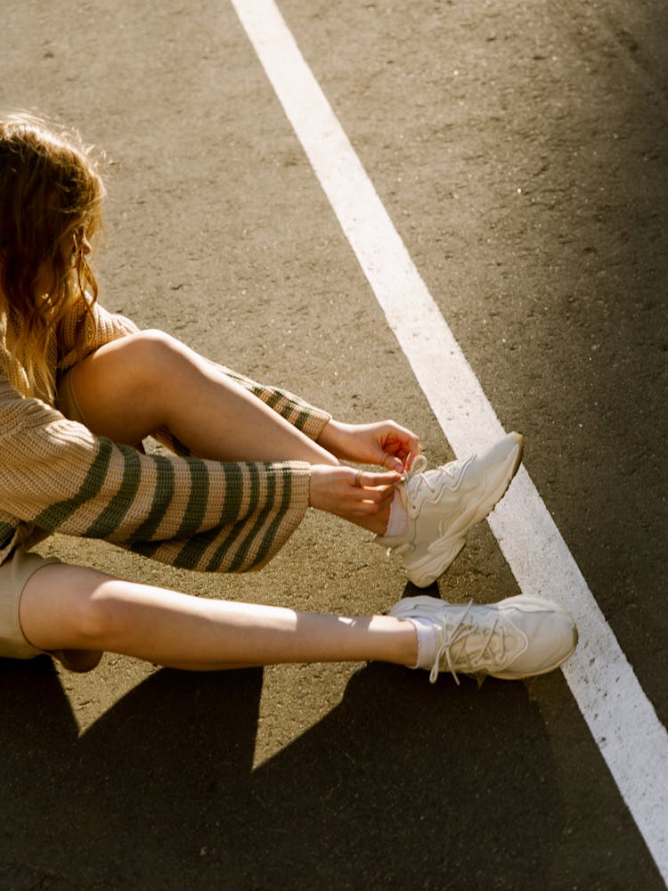 Woman Tying Her Shoes 