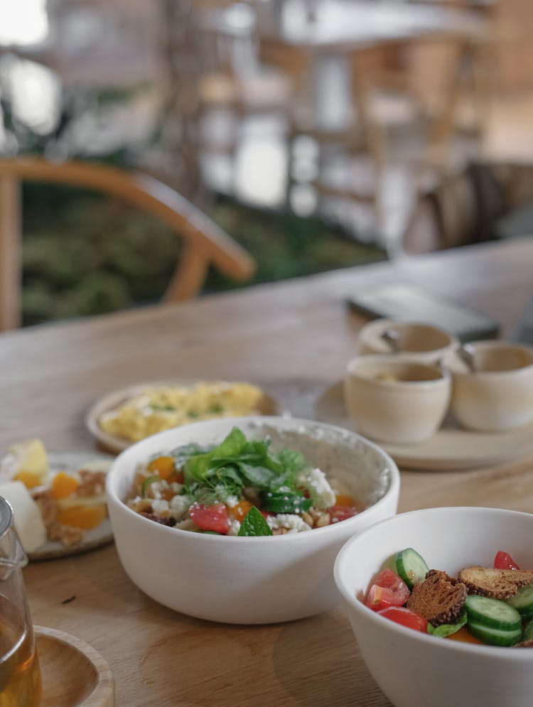 White Bowls Of Salad On Table