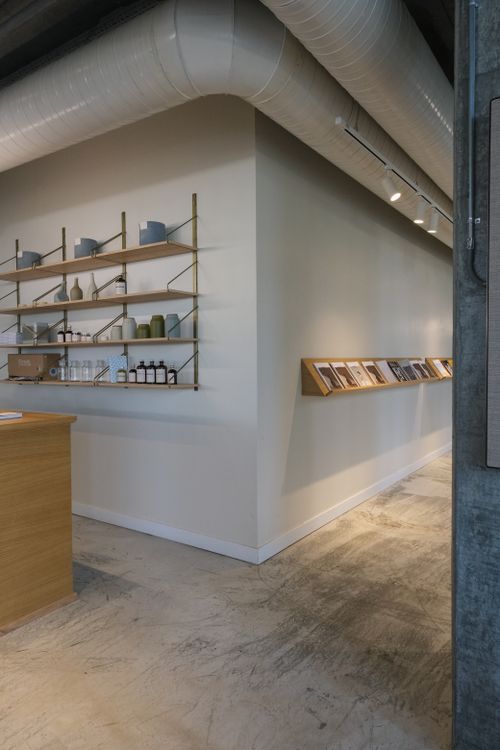 Free Contemporary minimalist interior space featuring wooden shelves and industrial venting. Stock Photo