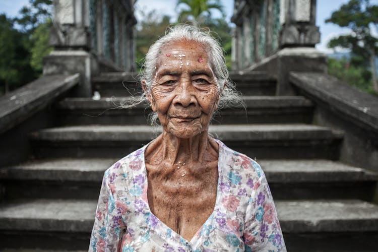 Portrait Of Elderly Woman On Stairs