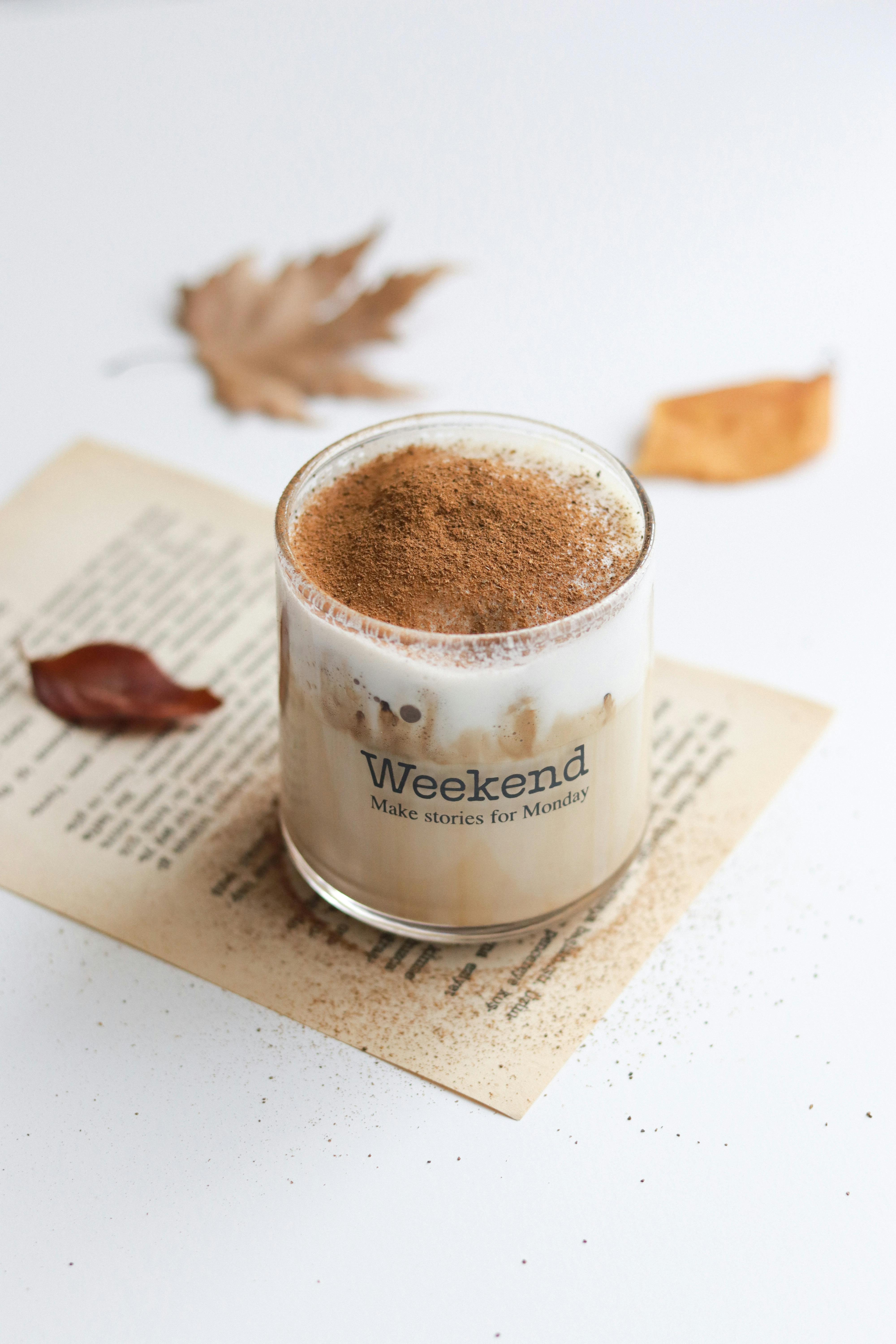 Close-up of a creamy coffee with a cinnamon topping, perfect for autumn vibes.