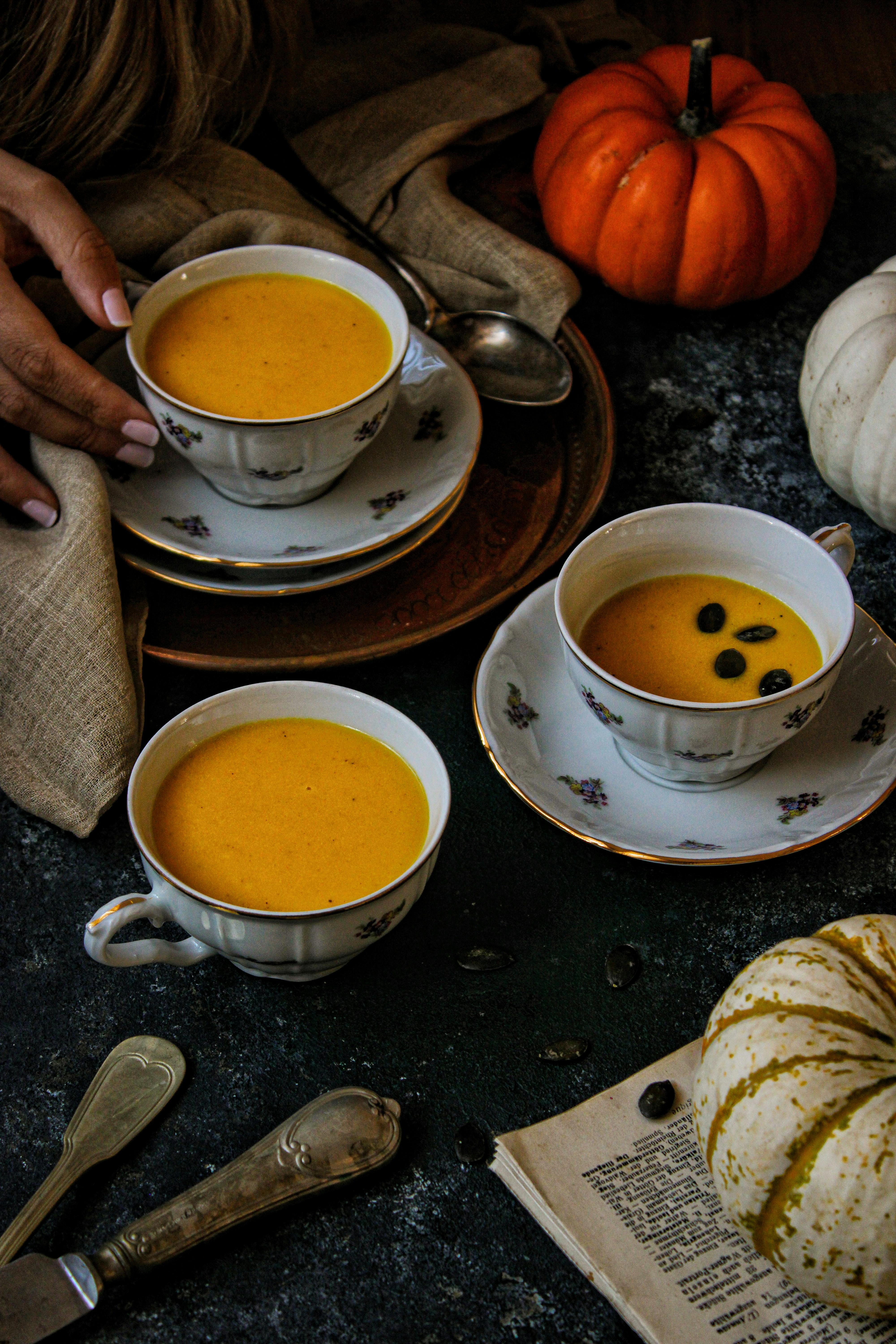 Warm and earthy pumpkin soup served in decorative ceramic cups, perfect for cozy autumn meals.