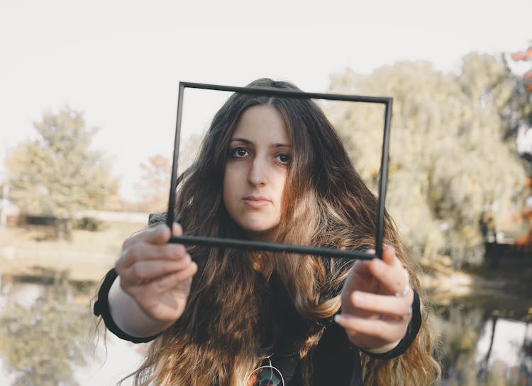 A Woman Holding A Frame