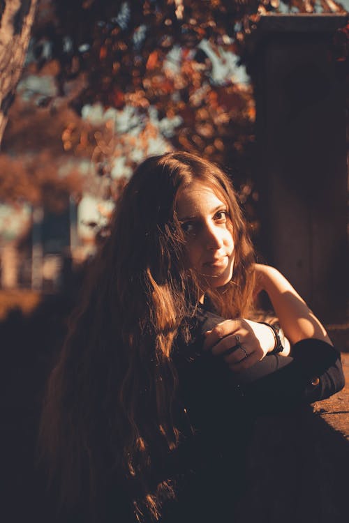 A Woman Leaning on Concrete Wall