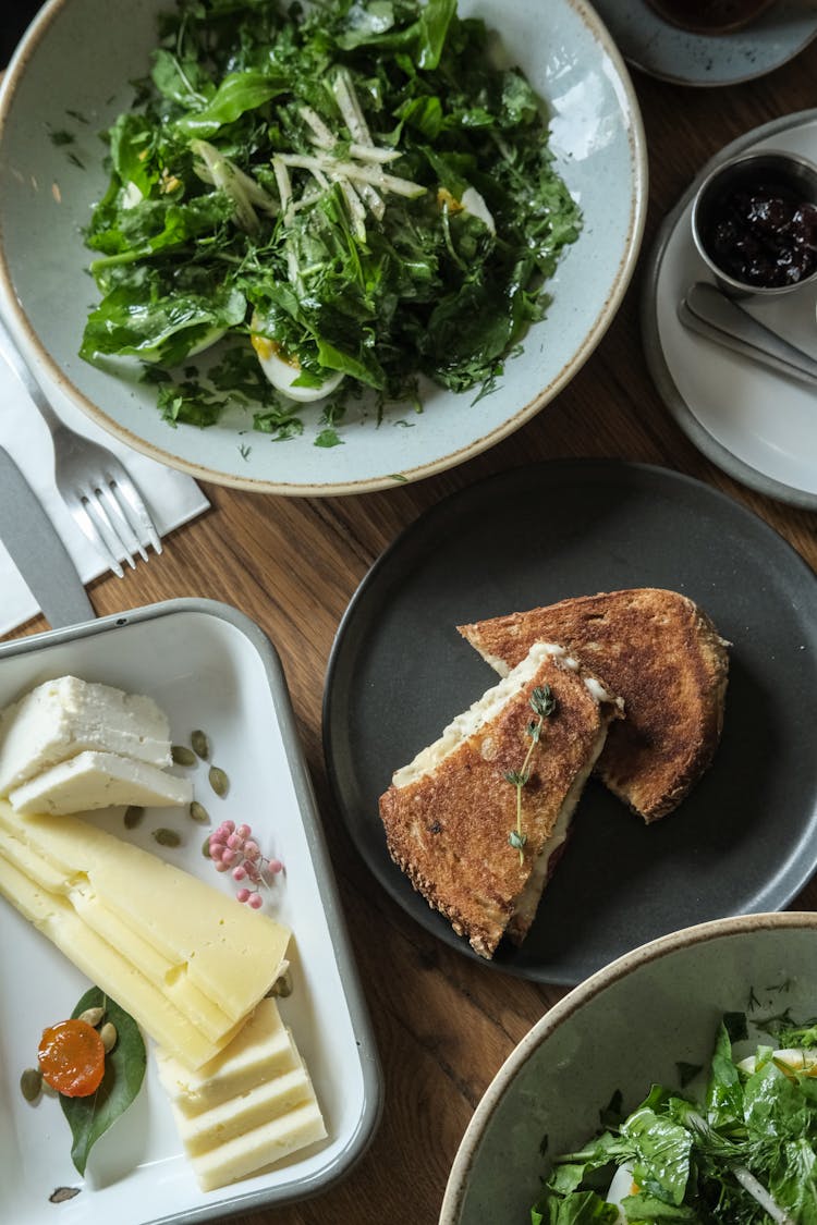 Cake, Cheese And Salad On Table