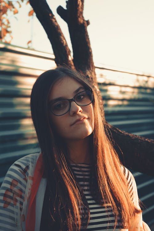 A Girl in Eyeglasses Wearing a Striped Shirt