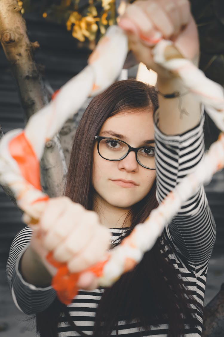 A Girl In Eyeglasses Holding A Frame