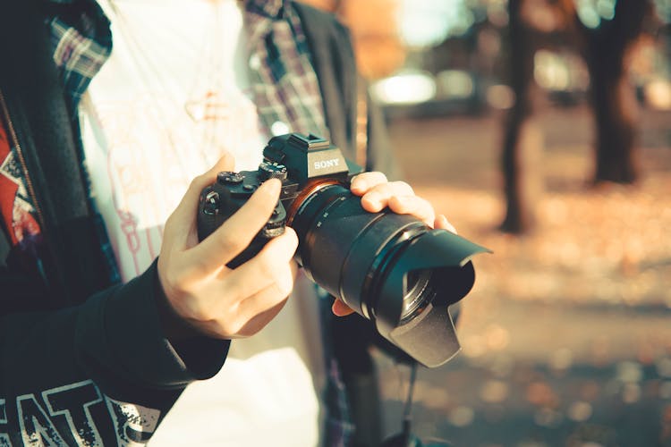 Hands Holding Professional Camera