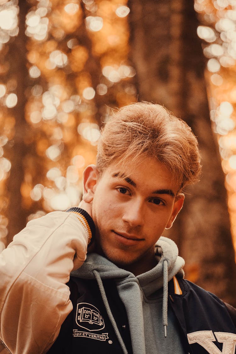 Portrait Of Young Man In Autumn Park