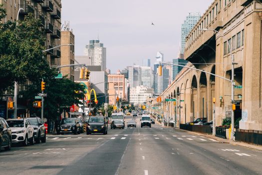 View of a busy street in New York City with skyscrapers and iconic landmarks in the background.