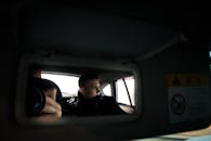 A Man in Black Jacket Inside the Car