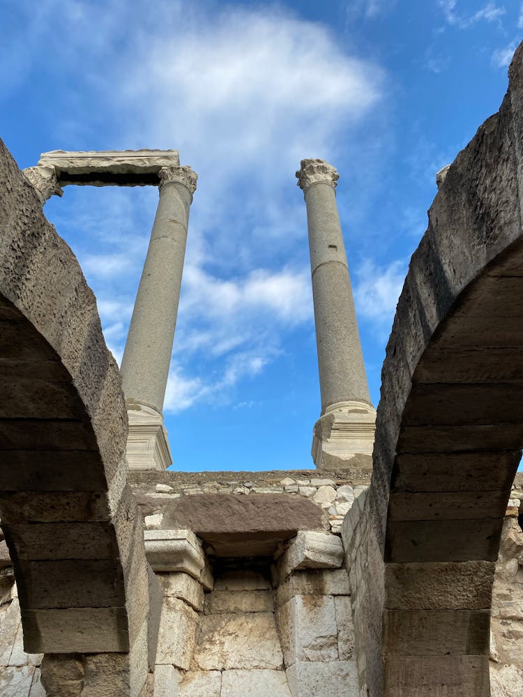 Ancient Column Ruins Against Blue Sky