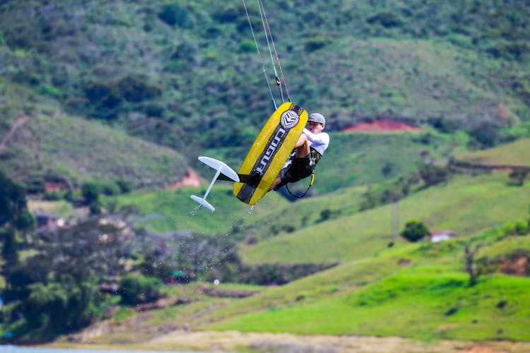 Man On Wakeboard Jumping High Above Water