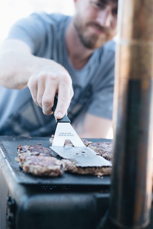 Man In Grey Crew-neck Shirt Frying Burgers