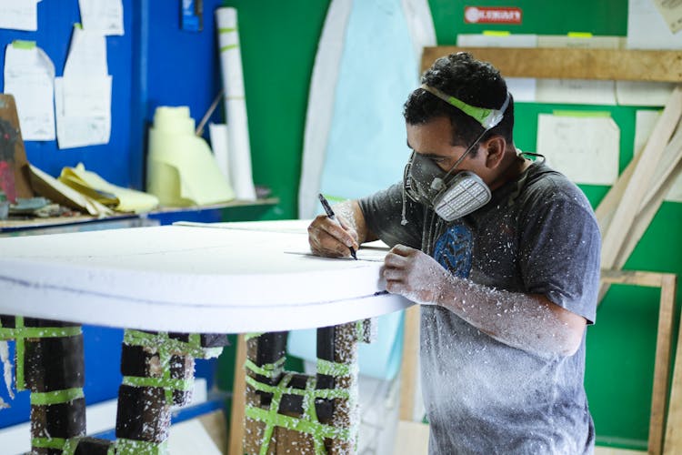 Man Working On A Wood Board