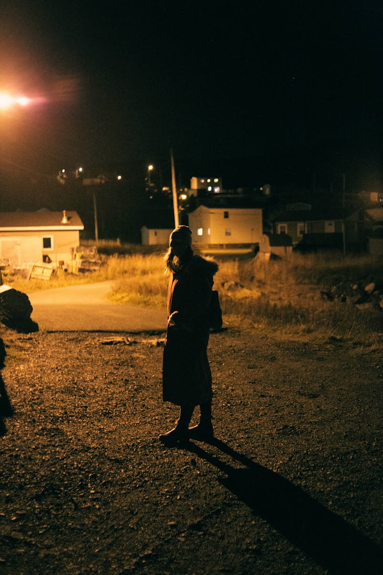 Woman In Village At Night