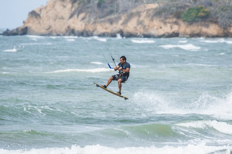 Kitesurfer Jumping On A Wave