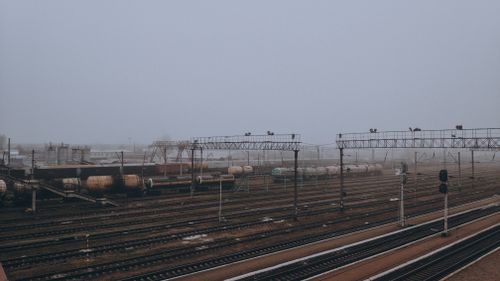 Free Moody winter scene of a foggy train station with tank wagons, tracks, and mist. Stock Photo