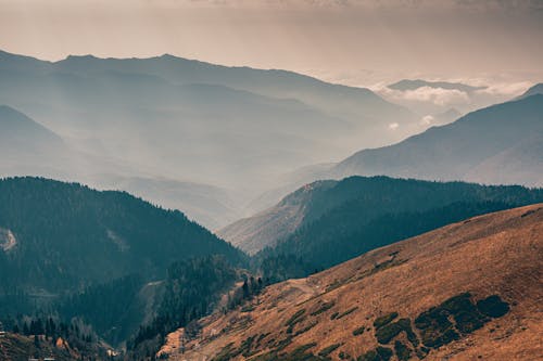 Brown and Green Mountains Under White Clouds