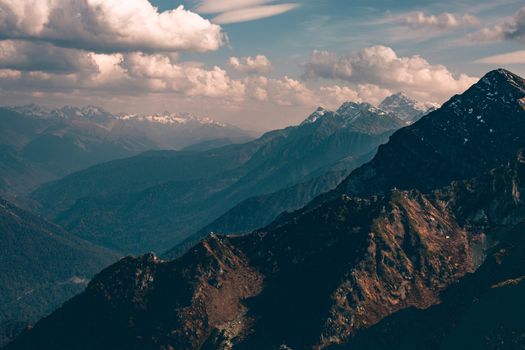Stunning aerial view of mountain range with dramatic clouds and natural light.