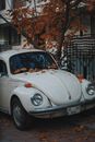 White Volkswagen Beetle Parked on Sidewalk