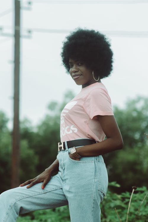 A Woman in Pink Crew Neck T-shirt and Blue Denim Jeans