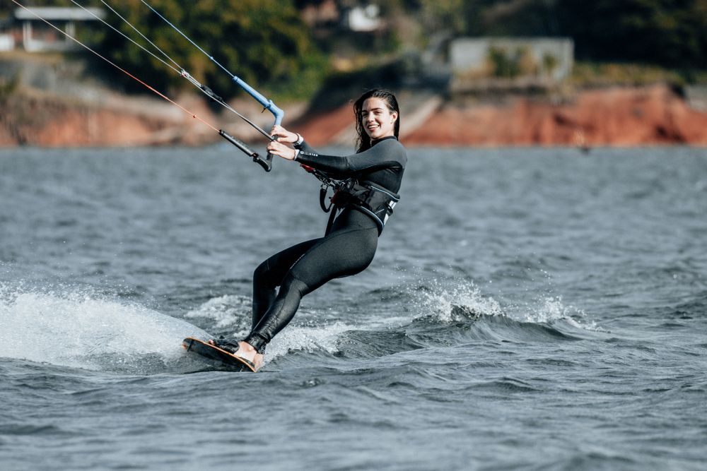 Smiling kitesurfer in a black wetsuit