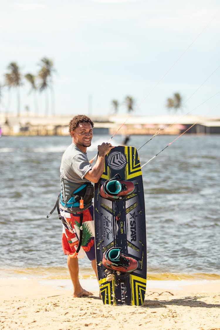 Smiling Man With Board On Beach