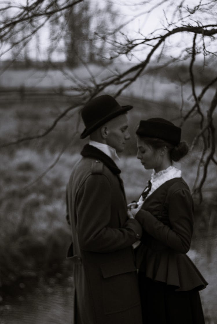 Young Couple In Retro Costumes Standing Face To Face 