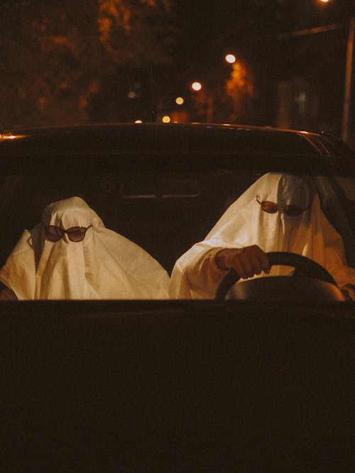 Two People in Ghosts Costumes in Car