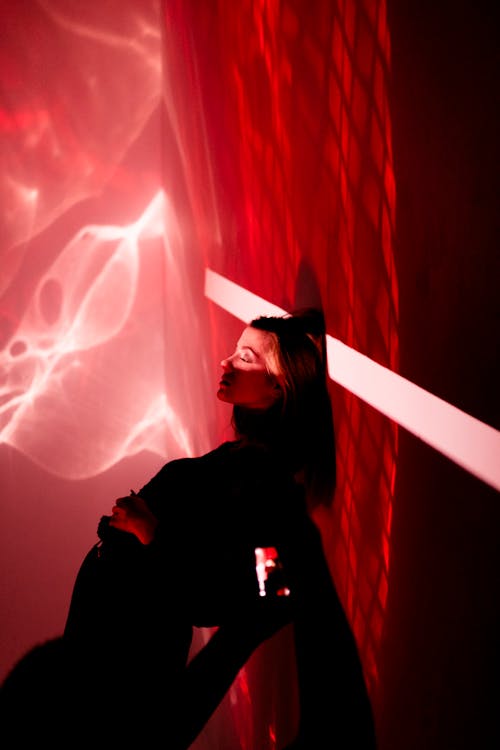 Woman in Dark Clothing in Red Light
