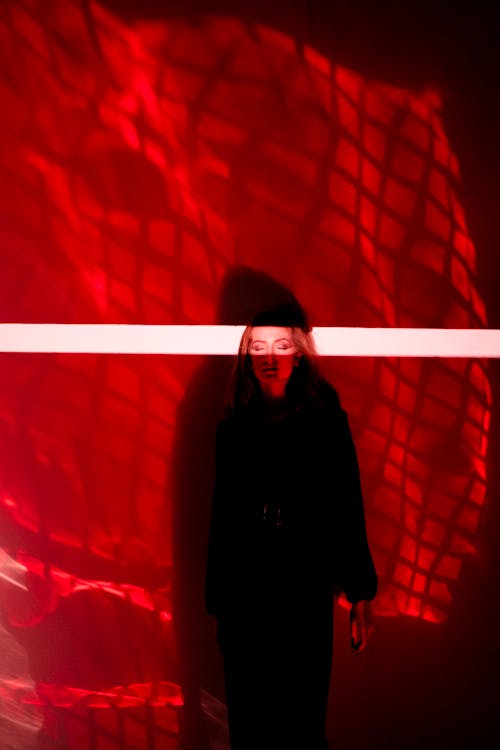 Woman in Dark Clothing in Red Light