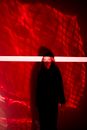 Woman in Dark Clothing in Red Light