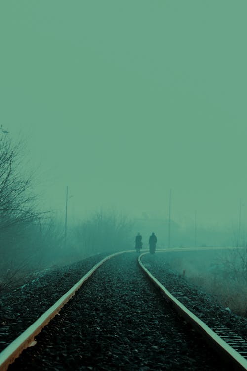 Person Walking on Train Tracks 