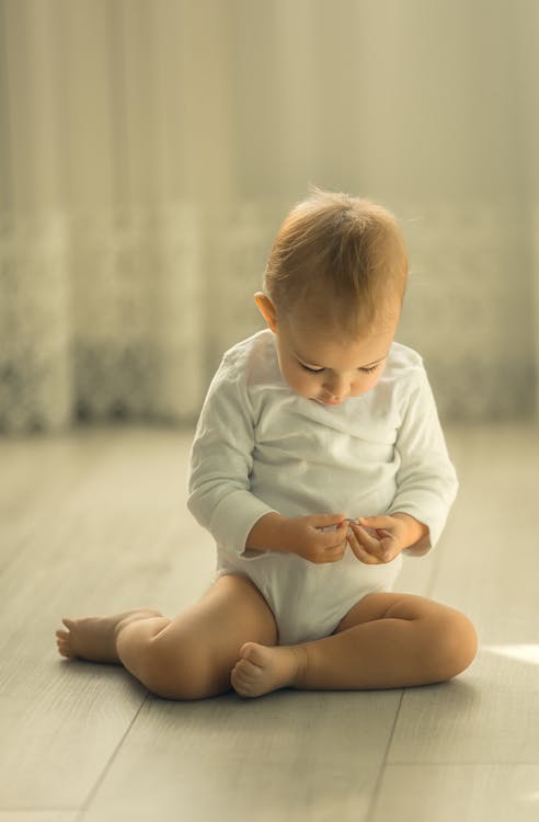 Free Cute Toddler sitting on Ground  Stock Photo