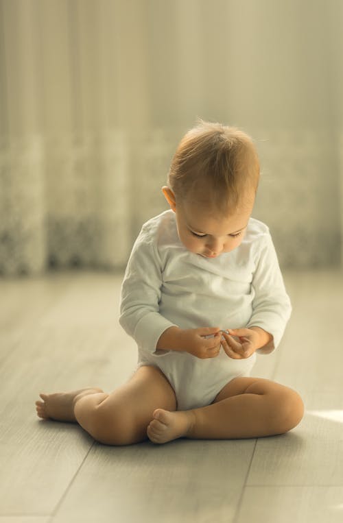 Free Cute Toddler sitting on Ground  Stock Photo